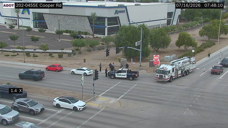 Police car and fire truck with emergency lights on at intersection