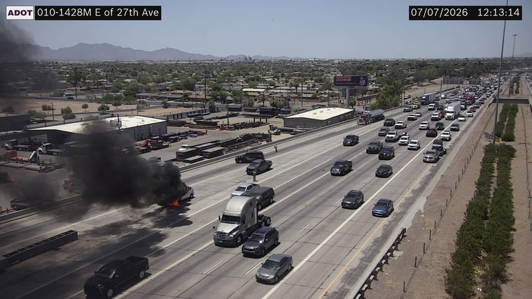 Vehicle on fire in the left lane