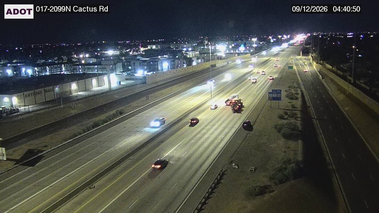 Tow truck with flashing lights assisting a vehicle in the right lane