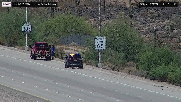 Police car with flashing lights on the shoulder