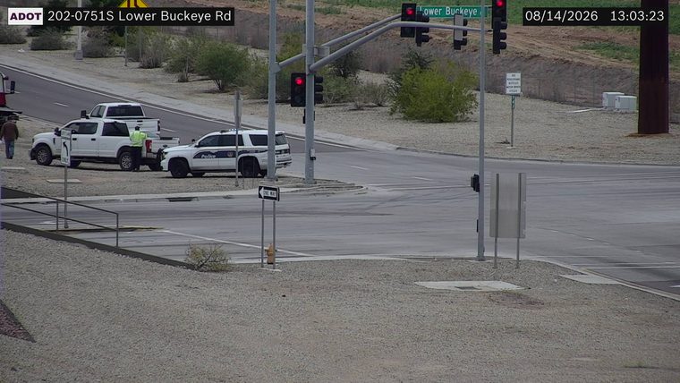 Police SUV and two pickup trucks pulled over on the side of the road