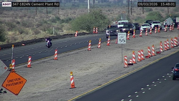 Construction cones and uneven pavement sign in the right lane