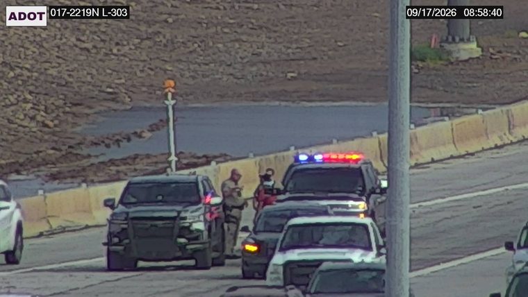 Police car with red and blue lights on the roadway