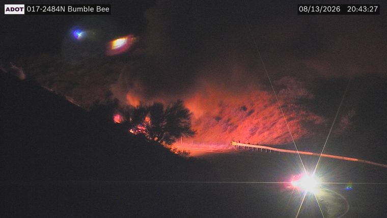 Fire and smoke on the hillside to the left of the roadway