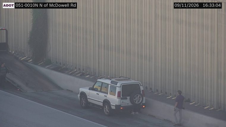 White SUV on the right shoulder