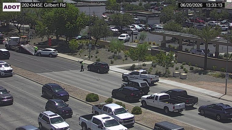 Tow truck assisting a white SUV on the left shoulder