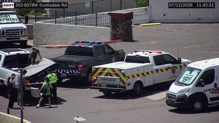 Trooper vehicle and motorist assistant vehicle with red and blue lights activated near a white pickup truck