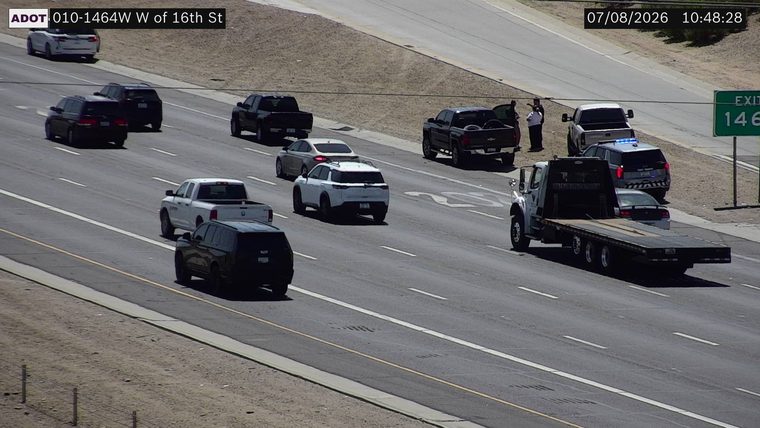 Police car with blue lights on the right shoulder