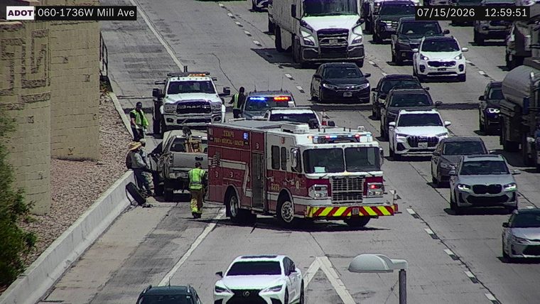 Fire truck and police car with lights on in the left lanes