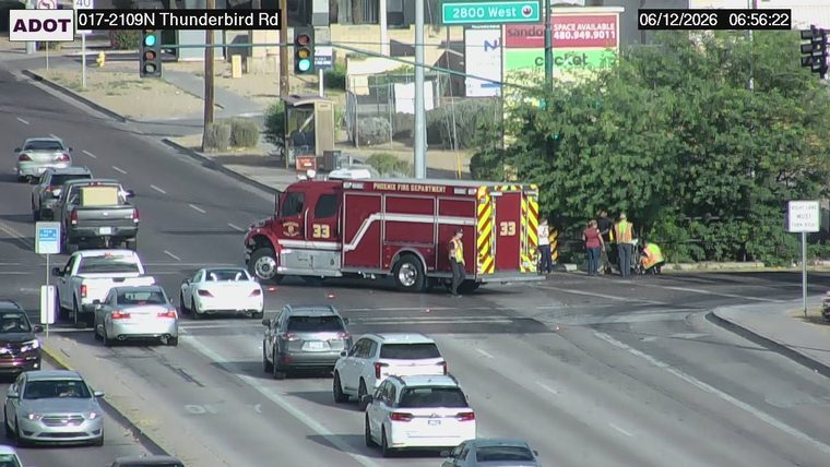Fire truck and several people near the intersection