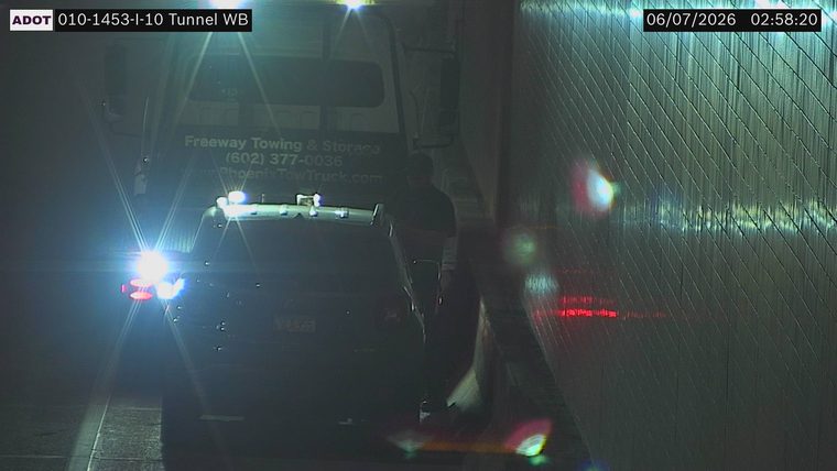 Tow truck with hazard lights on in the right lane
