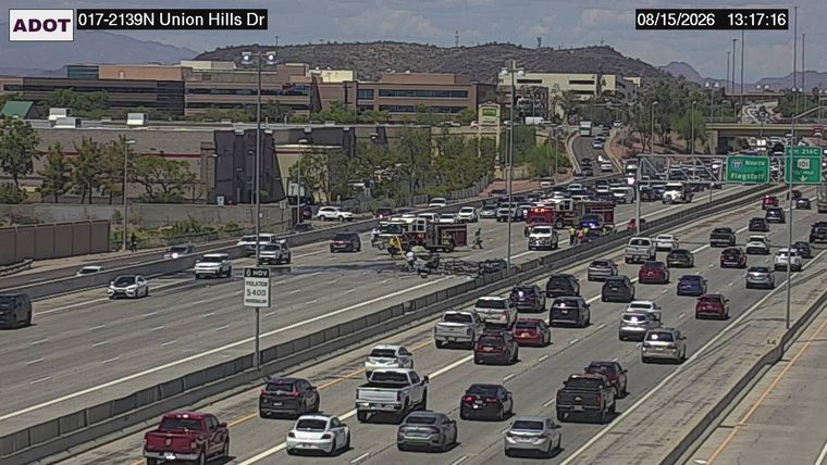 Fire truck and ambulance with emergency lights on in the left lanes
