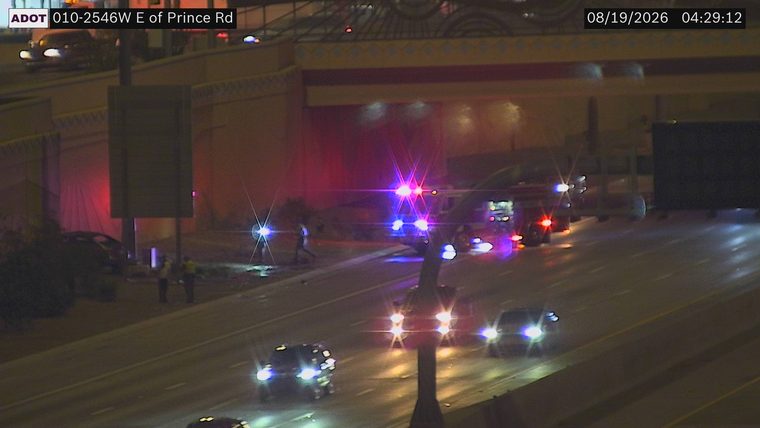 Multiple emergency vehicles with red and blue lights on the roadway
