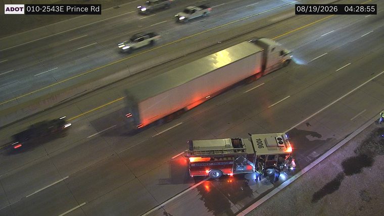 Fire truck with red and blue lights on the right shoulder