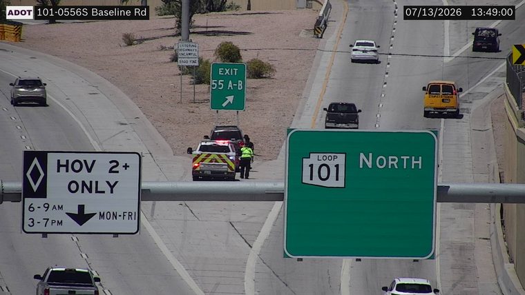 Police car with red and blue lights on the shoulder