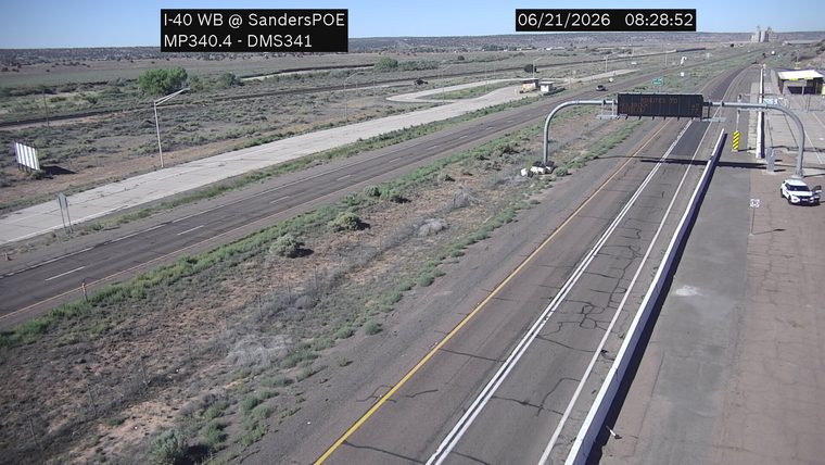 White vehicle on the right shoulder with the driver's door open