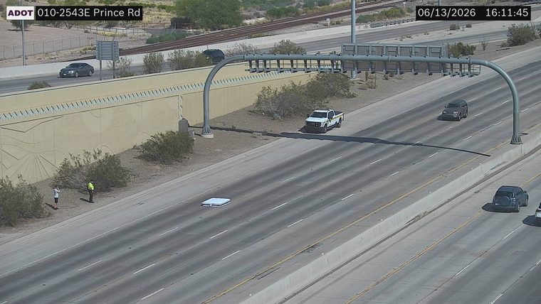 White pickup truck with yellow markings on the right shoulder
