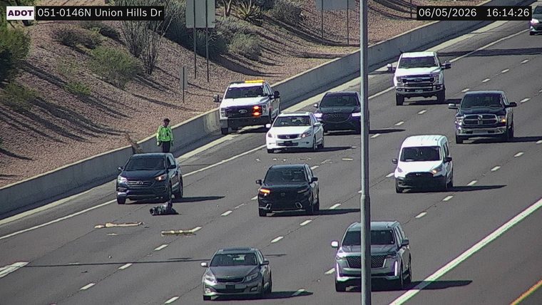 Person in high-visibility vest on the left shoulder