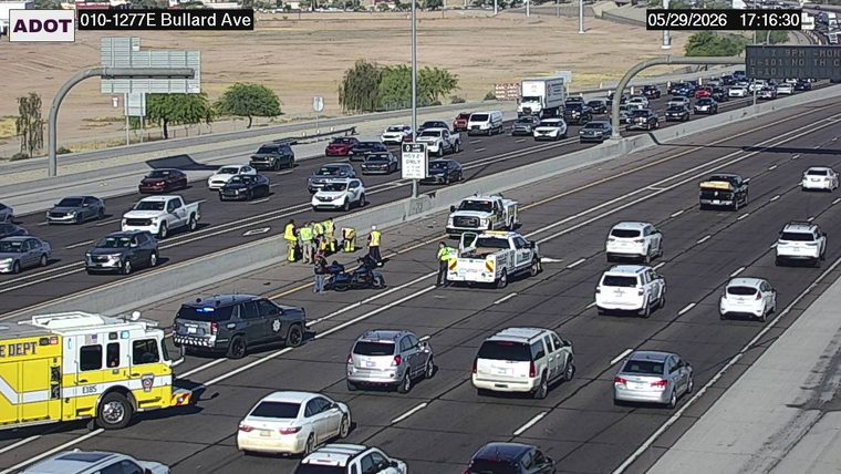 Fire truck and police SUV with lights on in the left lanes