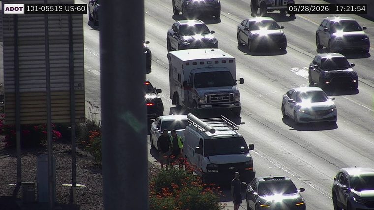 Ambulance and two people on the right shoulder