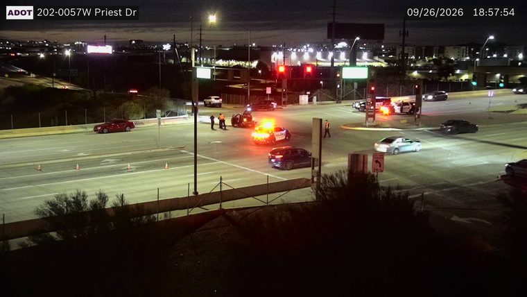 Police car with lights on in the intersection