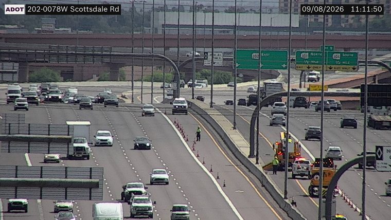 Construction cones and a worker in the left lane