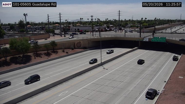 Dark SUV on the right shoulder with a person standing outside