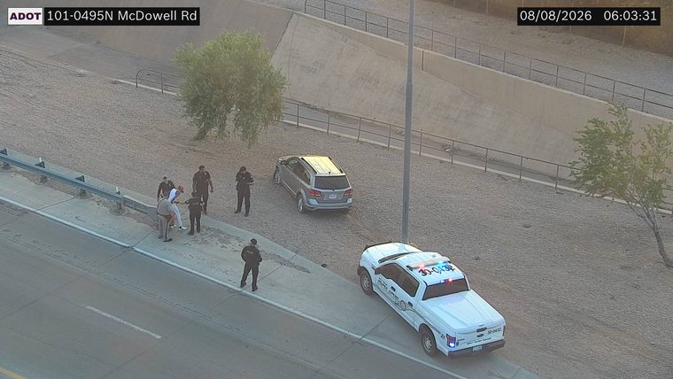 Police car with lights on the shoulder