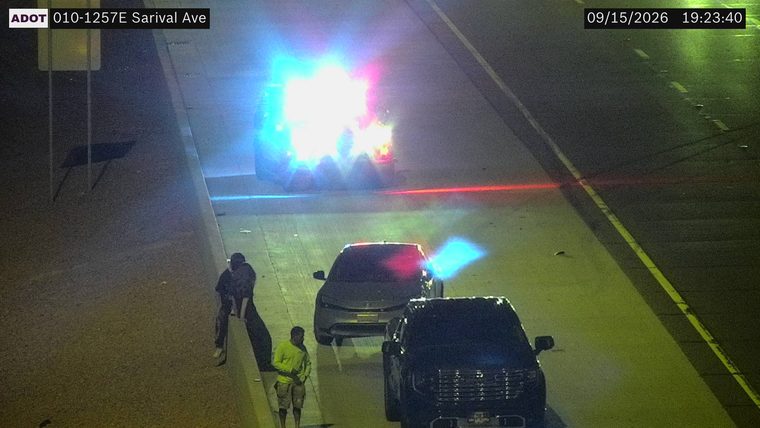 Vehicle on fire with emergency lights flashing in the left lanes