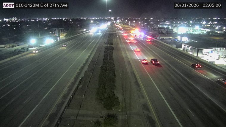 Multiple emergency vehicles with red and blue lights on the roadway