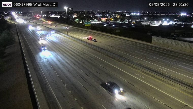 Police car with red and blue lights on the right shoulder
