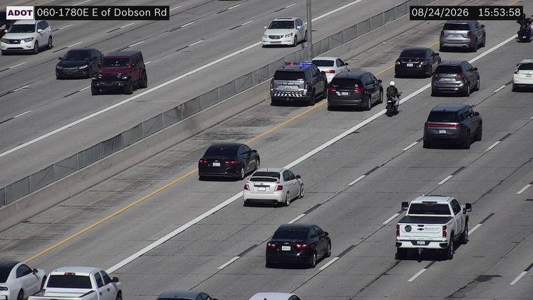 Police car with blue and red lights on in the left lane