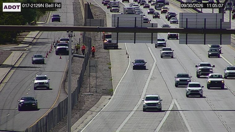 Construction cones and workers in the left lane