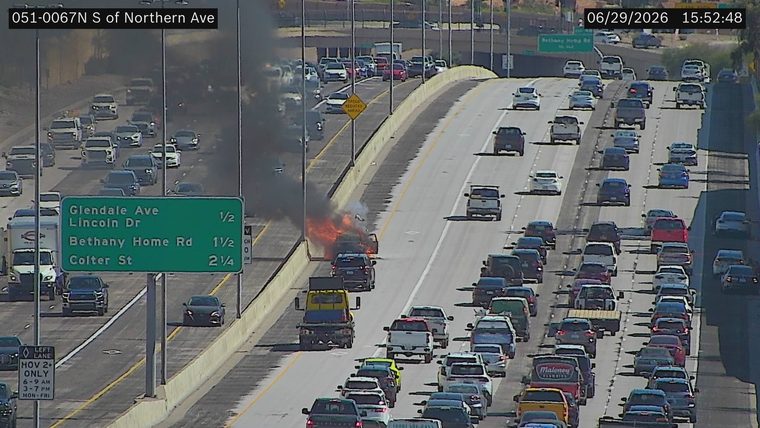 Vehicle on fire in the left lane