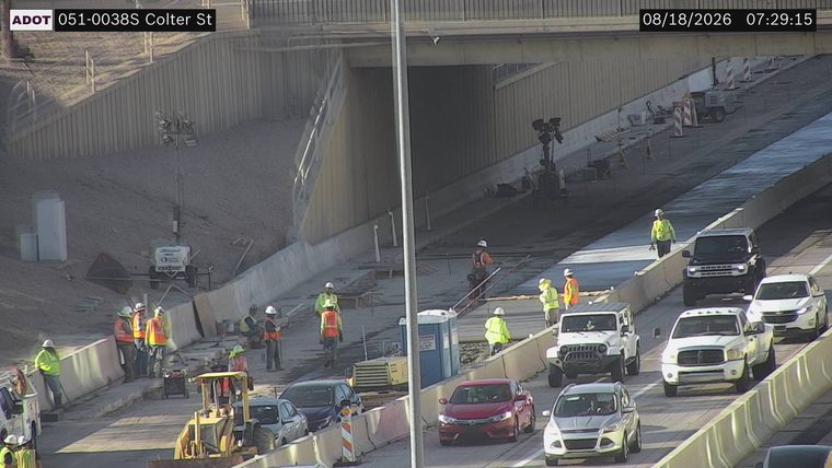 Construction workers and equipment in the right lane