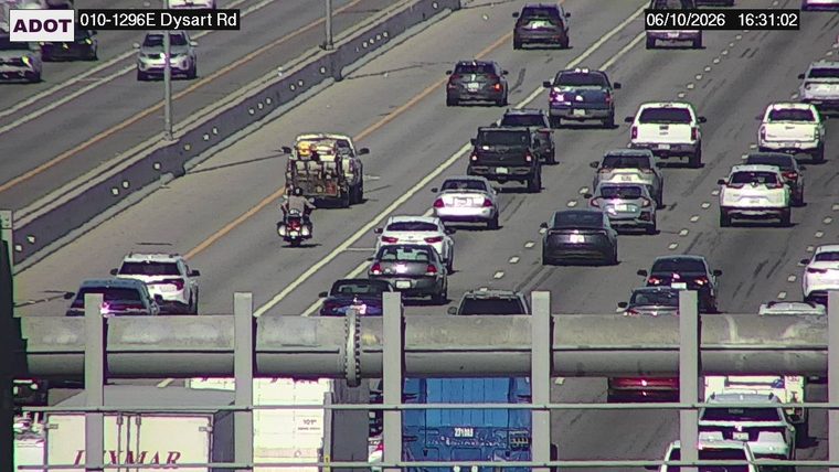 Fire truck and emergency vehicle with personnel on the right shoulder