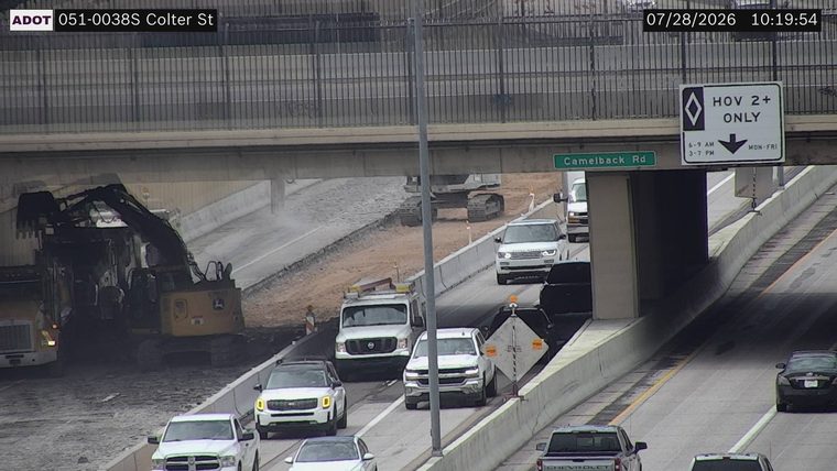 Construction equipment and workers in the left lanes