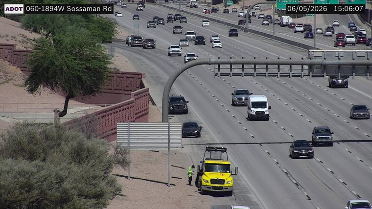 Tow truck and worker on the right shoulder