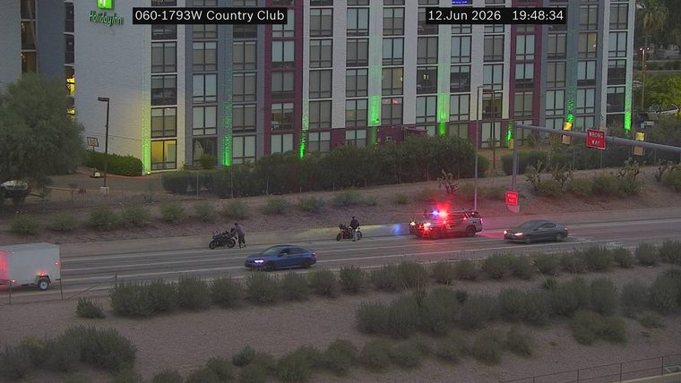 Police car with flashing lights on the right lane