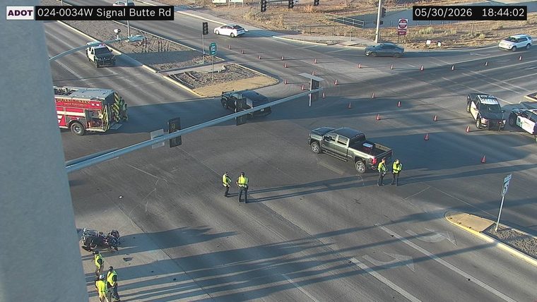 Motorcycle down in the intersection with debris and responders