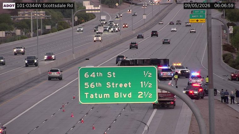 Tractor-trailer overturned across multiple lanes with emergency vehicles present