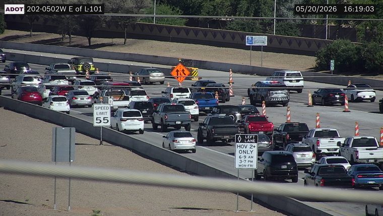 Police vehicle with emergency lights on near the right shoulder