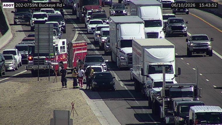 Fire truck and responders assisting a vehicle in the left lane