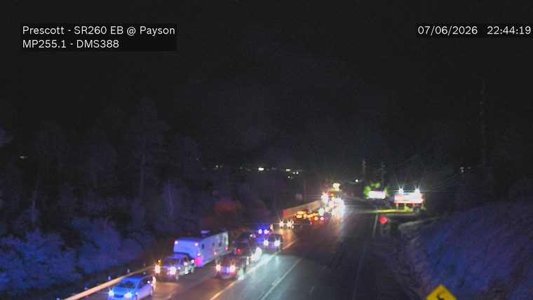 Multiple emergency vehicles with red and blue lights on the roadway