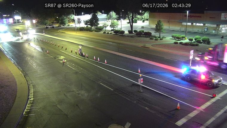 Police car with red and blue lights on in the right lane
