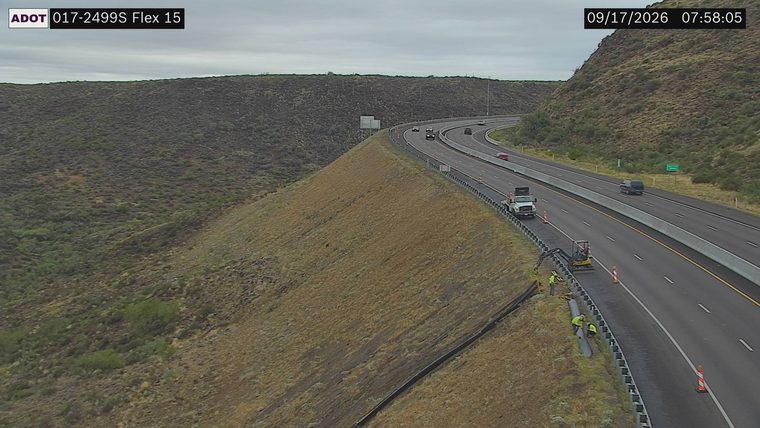 Construction workers and equipment on the right shoulder