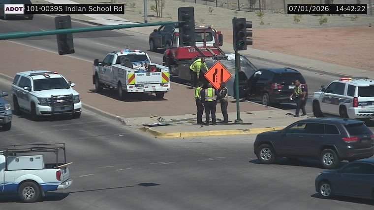 Police officers and ADOT incident response vehicle at a collision scene