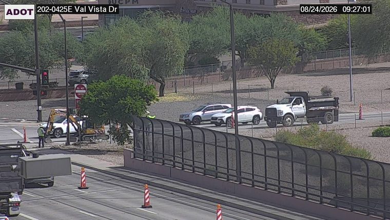 Construction worker and excavator in the left lane