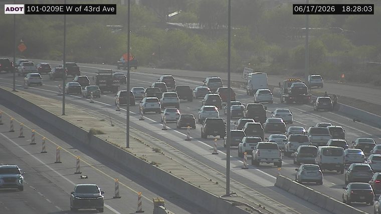 Tow truck and two individuals on the right shoulder