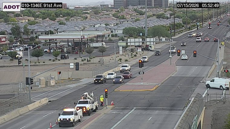 Tow truck and a worker with cones in the right lane